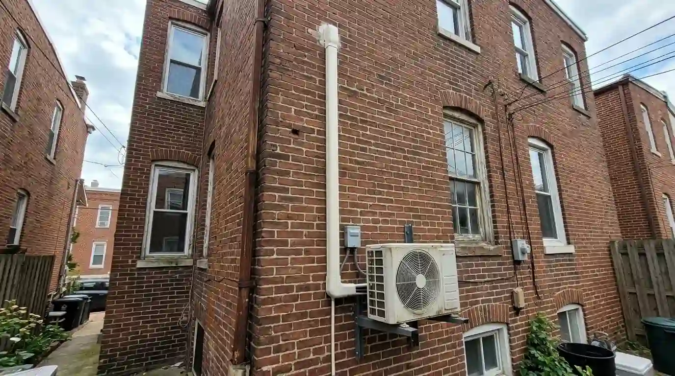 Mini-split line set cover on a brick rear wall